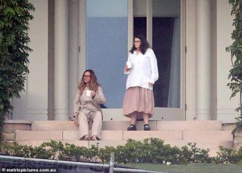 Home for the next 14 days! Julia Roberts (left, with a staff member) is settling into quarantine life after jetting into Australia to shoot her new movie Ticket to Paradise with George Clooney