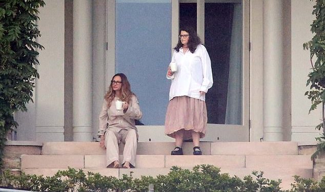 Home for the next 14 days! Julia Roberts (left, with a staff member) is settling into quarantine life after jetting into Australia to shoot her new movie Ticket to Paradise with George Clooney