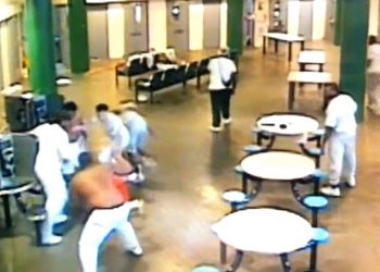 Surveillance footage posted to social media shows the suspects beating Boyd, in orange