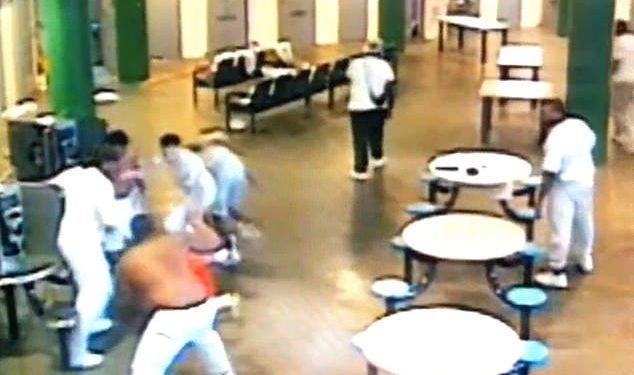 Surveillance footage posted to social media shows the suspects beating Boyd, in orange