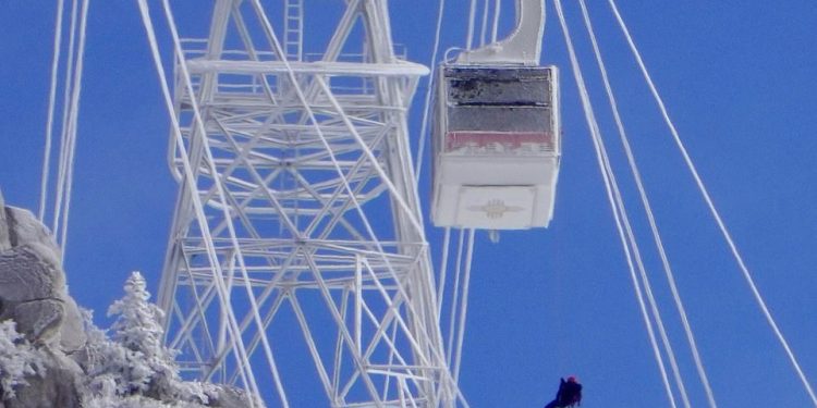 After being stuck on the frozen cable car for hours, the workers were finally rappelled to safety 85feet below, one by one