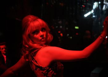 Anya Taylor-Joy poses in deep red light in Last Night in Soho