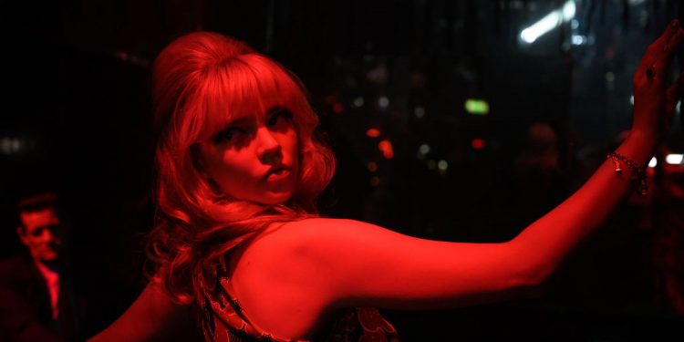 Anya Taylor-Joy poses in deep red light in Last Night in Soho