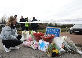 Jane Lowry 19, who played hurling with Ashling Murphy for Kilcormac Killoughey lays flowers with other floral tributes left near to the Grand Canal in Tullamore, County Offaly, where Ashling Murphy was murdered on Wednesday evening