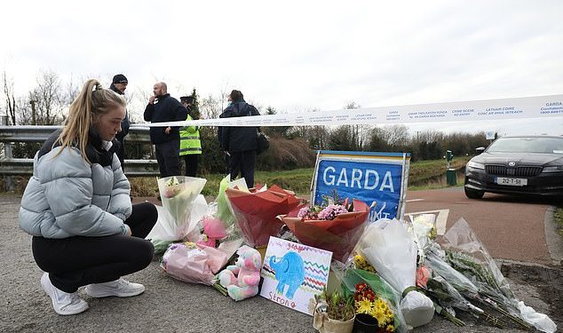 Jane Lowry 19, who played hurling with Ashling Murphy for Kilcormac Killoughey lays flowers with other floral tributes left near to the Grand Canal in Tullamore, County Offaly, where Ashling Murphy was murdered on Wednesday evening