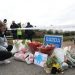 Jane Lowry 19, who played hurling with Ashling Murphy for Kilcormac Killoughey lays flowers with other floral tributes left near to the Grand Canal in Tullamore, County Offaly, where Ashling Murphy was murdered on Wednesday evening