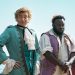 Foppish "gentleman pirate" Stede (Rhys Darby), left, with his crew member Oluwande (Samson Kayo), right, stand on the deck of a ship.