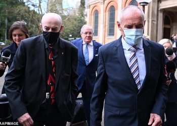There were tense scenes as Chris Dawson (right) and his brother Peter (left) arrived at the NSW Supreme Court for the murder trial verdict on Tuesday.