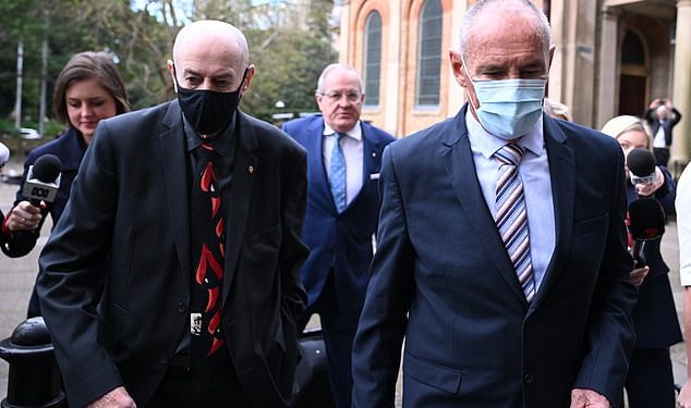 There were tense scenes as Chris Dawson (right) and his brother Peter (left) arrived at the NSW Supreme Court for the murder trial verdict on Tuesday.